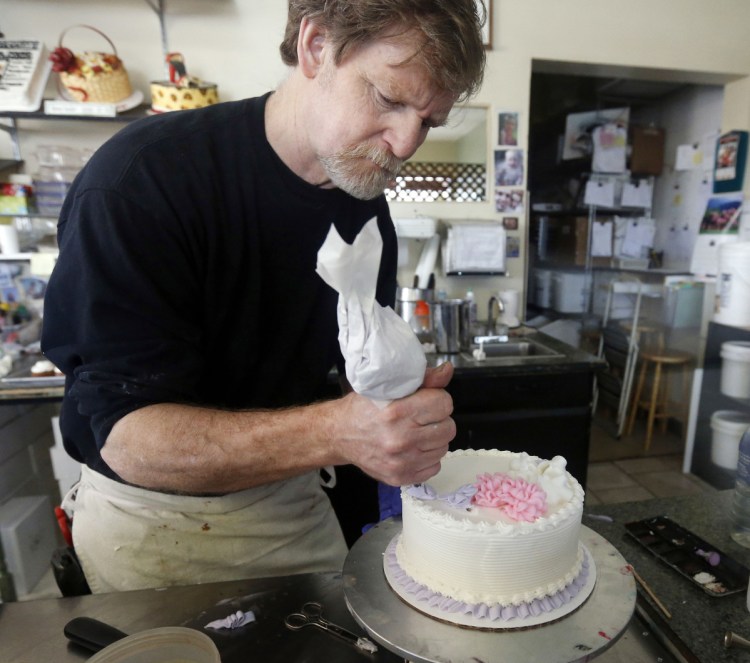 Masterpiece Cakeshop owner Jack Phillips decorates a cake inside his store in Lakewood, Colo. The Supreme Court is setting aside a Colorado court ruling against a baker who wouldn't make a wedding cake for a same-sex couple. But the court is not deciding the big issue in the case, whether a business can refuse to serve gay and lesbian people.