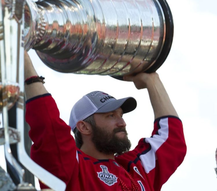 Alex Ovechkin holds up the Stanley Cup during a victory parade Tuesday in Washington, D.C. The Caps beat the Golden Knights in five games for their first title.