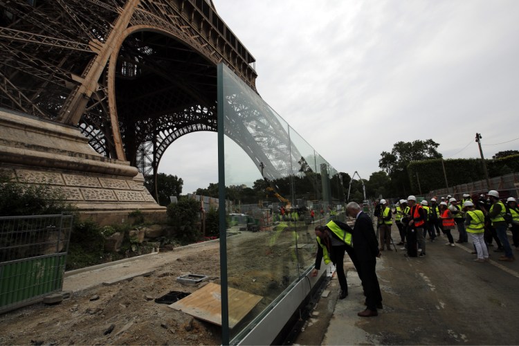 The new security bulletproof glass barrier under construction around the Eiffel Tower in Paris.            