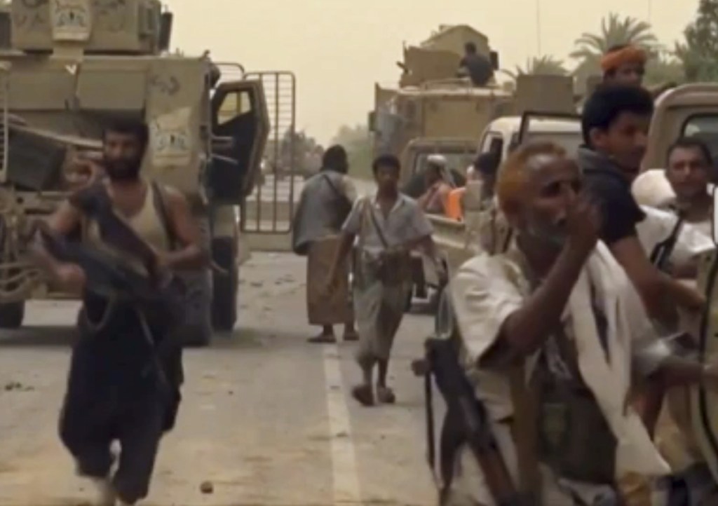 This still image taken from video provided by Arab 24 shows Saudi-led forces gathering to retake the international airport of Yemen's rebel-held port city of Hodeida from the Shiite Houthi rebels Saturday.