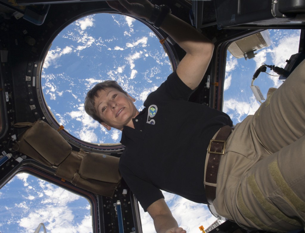 Astronaut Peggy Whitson is shown on the International Space Station, with the Earth in the background, in 2016.