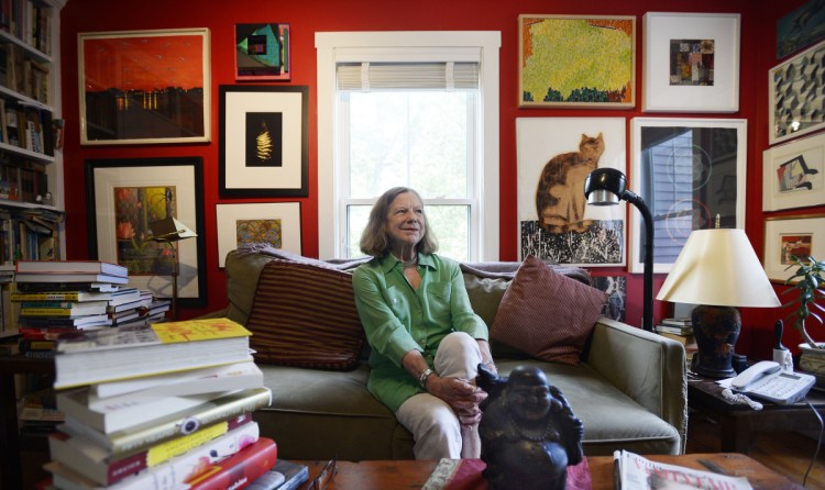 Anne Zill, who recently retired as art director of the Art Gallery at UNE in Portland, sits in the library of her Portland home Thursday. "I see my life as ... one great adventure after another," she said.
