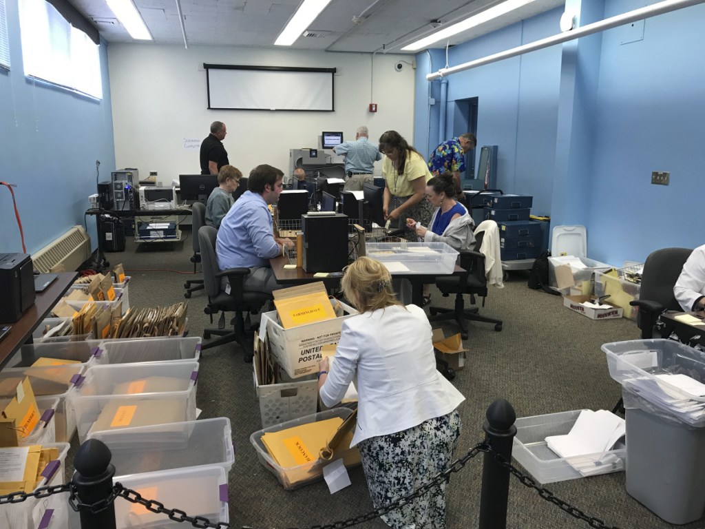 Workers in the Maine Secretary of State's Office return Monday to the task of scanning and downloading voter ballots ahead of a ranked-choice calculation on Tuesday.