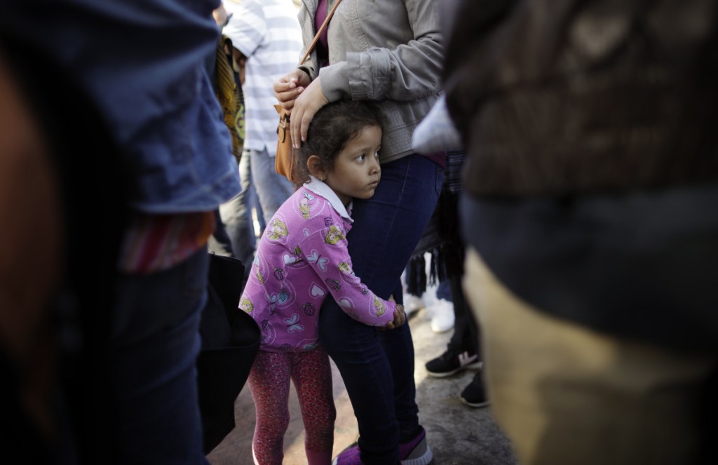 Nicole Hernandez holds onto her mother June 13 as they wait with others in Tijuana, Mexico, to request political asylum in the U.S. On the Senate floor Monday, independent Maine Sen. Angus King said the White House created the family separation policy and could easily end it.