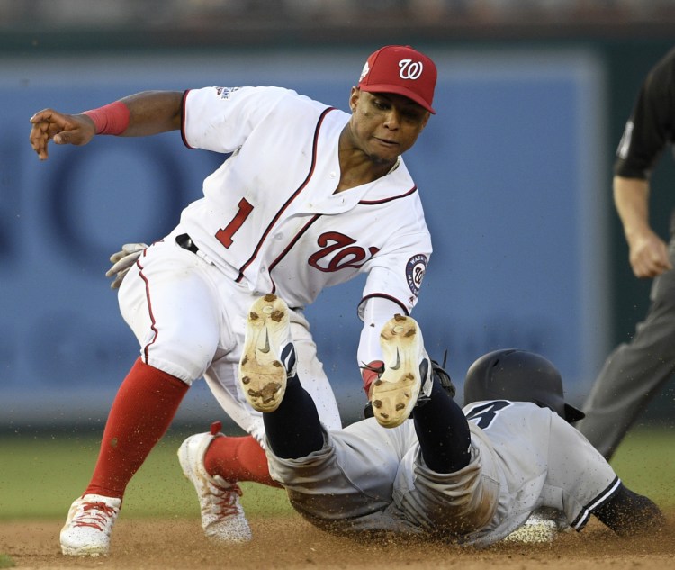 Didi Gregorius of the Yankees is tagged out by Nationals second baseman Wilmer Difo on a stolen-base attempt during New York 4-2 win in the second game of a doubleheader Monday night.