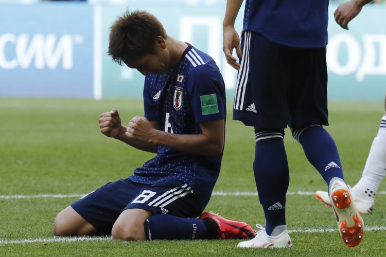 Genki Haraguchi celebrates the 2-1 win during Japan's  group H match against Colombia at the World Cup on Tuesday.