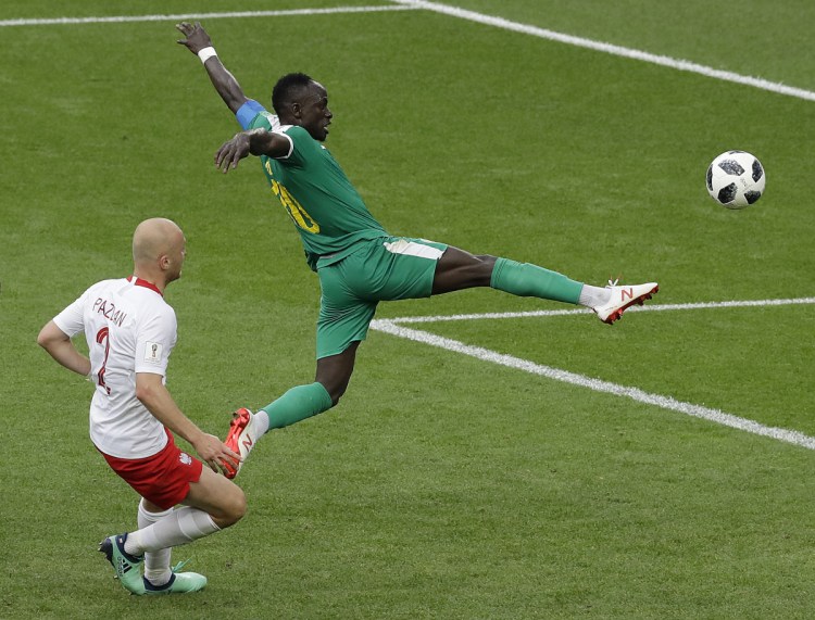 Senegal's Sadio Mane, right, and Poland's Michal Pazdan challenge for the ball during their match at the 2018 soccer World Cup in the Spartak Stadium in Moscow on Tuesday. Senegal won, 2-1.