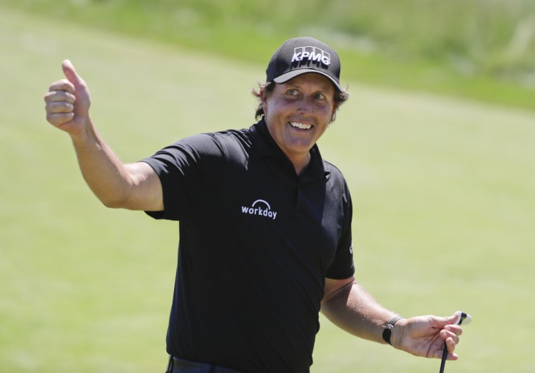 Phil Mickelson reacts after sinking a putt on the 13th hole during the final round of the U.S. Open Golf Championship, Sunday, June 17, 2018, in Southampton, N.Y. (AP Photo/Frank Franklin II)