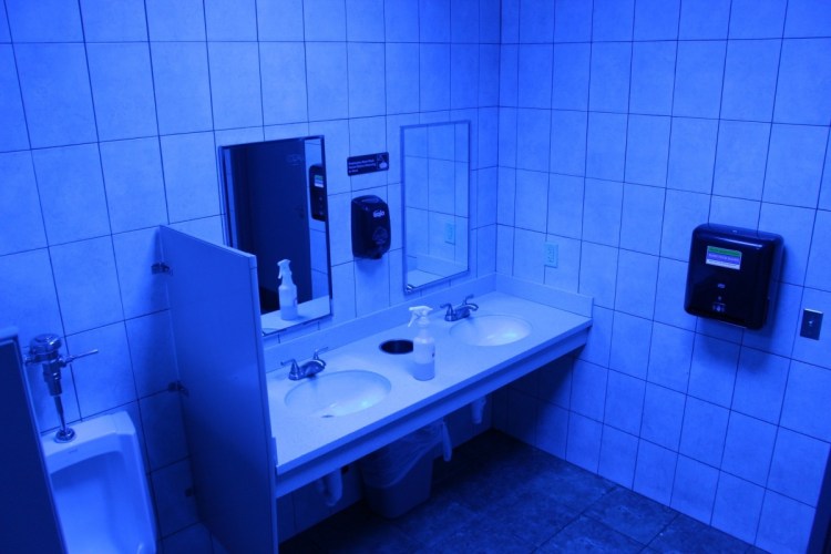 A public bathroom bathed in blue light is seen at this Turkey Hill convenience store in Wilkes-Barre, Pa. The chain has installed the blue light bulbs in as many as 20 stores in hopes of discouraging drug use by making it harder for people to see their veins.