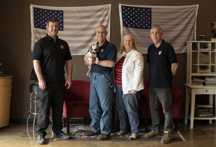 The team at Honor Defense, a gunmaker outside Atlanta, includes owner Gary Ramey, second from left, who says two credit card processing companies refused his business because of what Honor Defense makes and sells. Ramey said the companies shouldn't be "infusing politics into business."