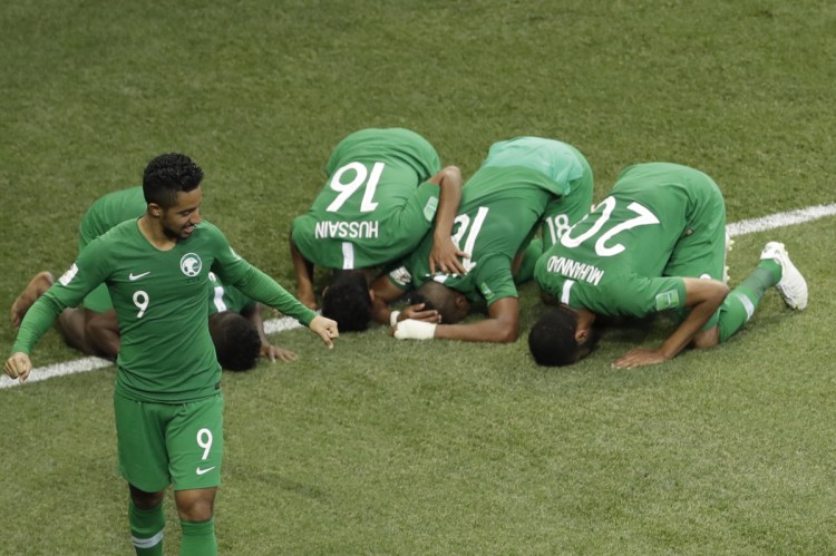 Saudi Arabia's Salem Aldawsari , second from right, celebrates with teammates after he scored his side's winning goal during their match against Egypt at the 2018 World Cup on Monday. Saudi Arabia won 2-1.