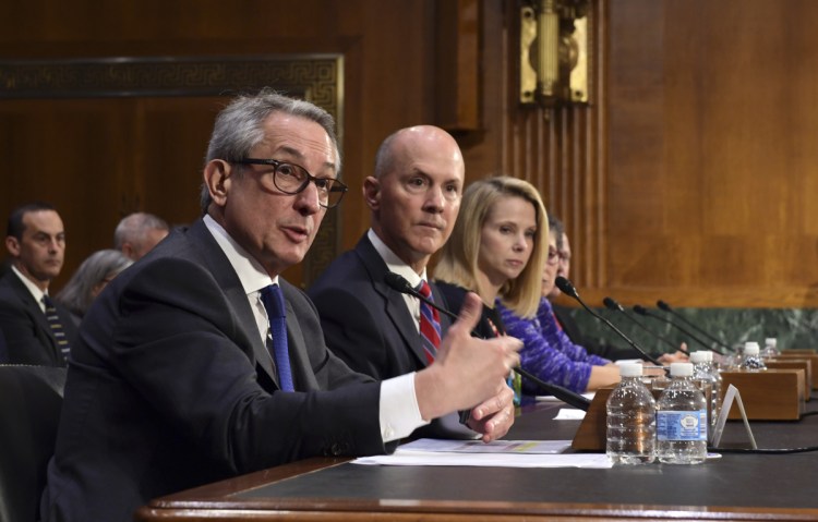 Paulino do Rego Barros, Jr., left, interim Chief Executive Officer of Equifax, Inc., sitting with Richard Smith, center, former Chief Executive Officer of Equifax, Inc., and former Yahoo! Chief Executive Officer Marissa Mayer, right, is shown testifying before the Senate Commerce Committee on Capitol Hill in Washington on Nov. 8, 2017, during a hearing on protecting consumers from data breaches.