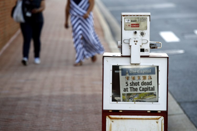 A Capital Gazette newspaper rack displays the day's front page on Friday in Annapolis, Maryland. A man armed with smoke grenades and a shotgun attacked journalists in the newspaper's building Thursday, killing several people before police quickly stormed the building and arrested him, police and witnesses said.