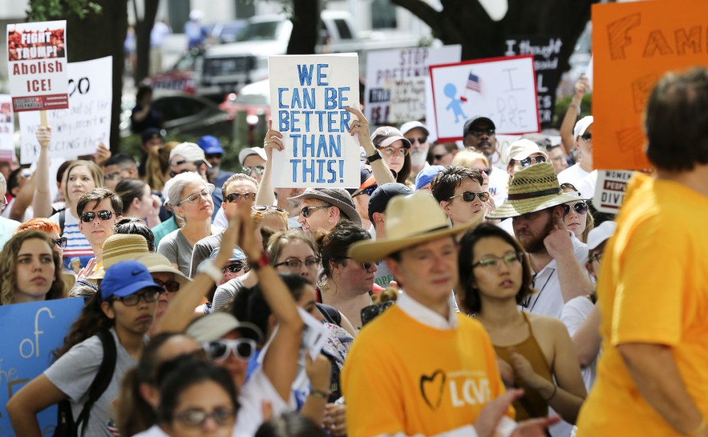 Protestors hold signs during an immigration rally in Houston that started at City Hall and ended at U.S. Sen. Ted Cruz's office on Saturday, June 30, 2018 in Houston. Rallies were held across the nation calling on federal agencies to reunite families separated at the border under Trump's "zero tolerance" policy, as well as calling for the abolishment of ICE.