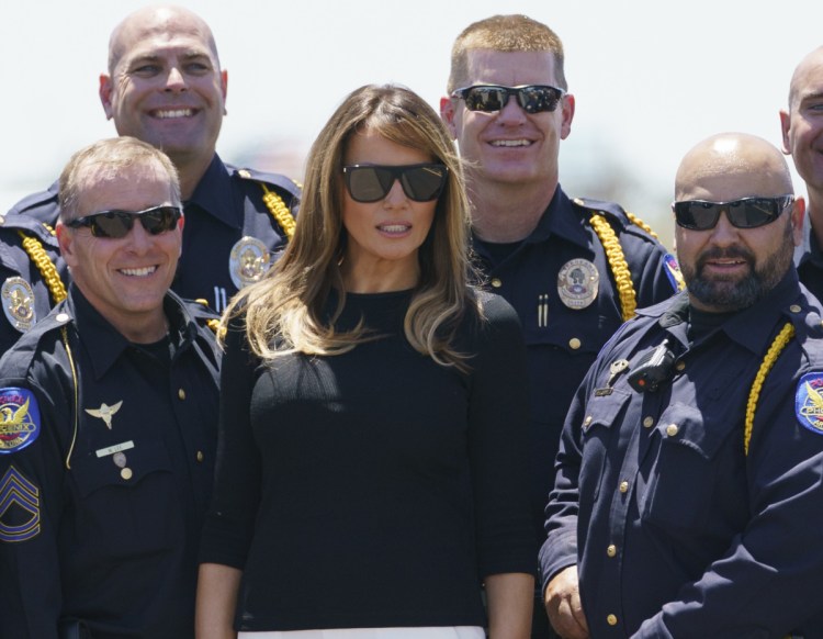 First lady Melania Trump takes a picture with members of law enforcement at Sky Harbor International Airport in Phoenix on Thursday en route to Washington.