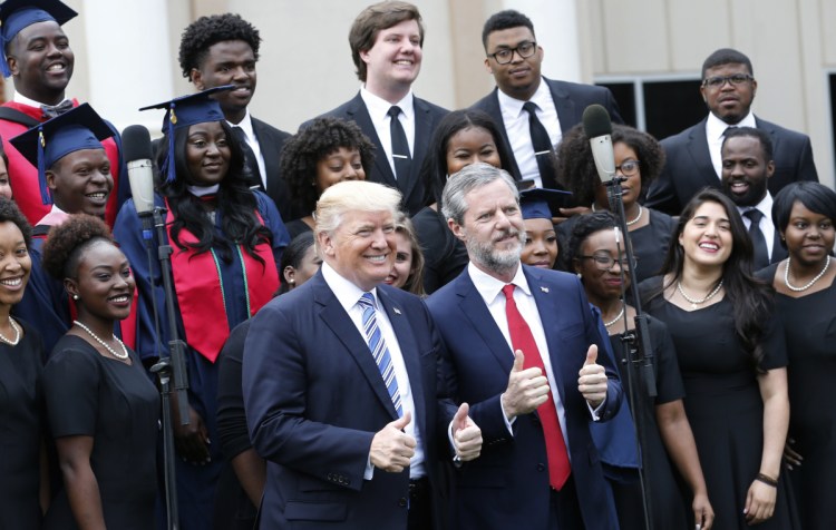 President Trump poses with Liberty University president, Jerry Falwell Jr., in front of a choir during commencement ceremonies at the school last year in Lynchburg, Va. Trump's next court pick will likely lead to a reversal in Roe v. Wade.