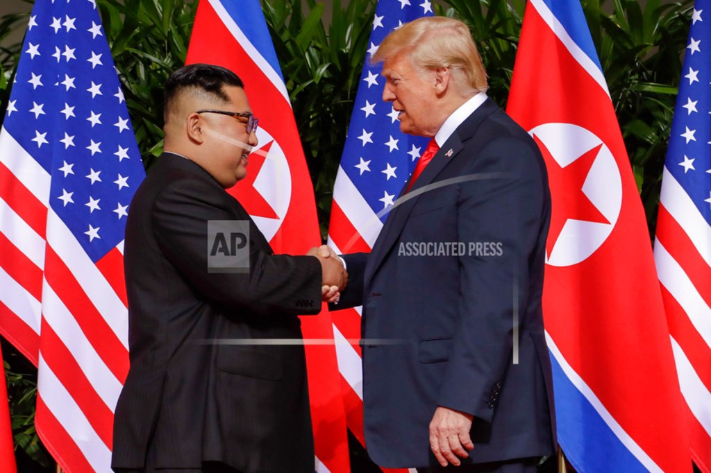 President Trump shakes hands with North Korea leader Kim Jong Un at the Capella resort on Sentosa Island Tuesday in Singapore. 