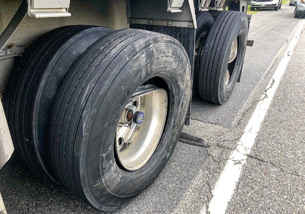 The wheels of a tractor-trailer on the side of Skowhegan Road in Fairfield appear damaged Friday morning. The tractor-trailer was involved in a collision with a 2002 Buick LeSabre that sent one person to the hospital with injuries that police did not believe were life threatening.