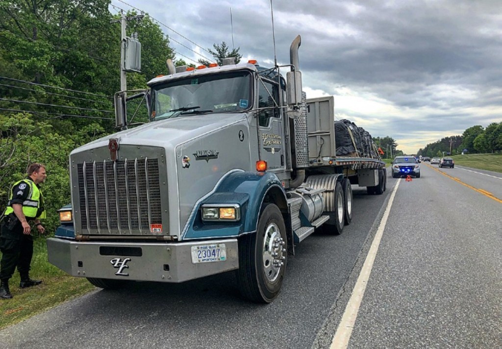 A tractor-trailer is seen parked on the side of Skowhegan Road Friday morning after it was struck by another vehicle traveling to Fairfield. The driver of the tractor-trailer, Louis Besquenne, who was driving for Holliston Logistics out of Slatersville, Rhode Island, said that he saw the LeSabre crossing the center line but did not want to veer the truck off the road.