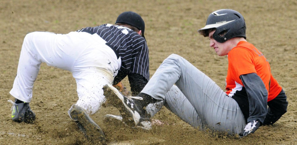 Staff photo by Joe Phelan 
 Lincoln Academy third baseman Basel White collides with Gardiner baserunner Cole Lawrence during a Kennebec Valley Athletic Conference Class B game at Hoch Field in Gardiner.