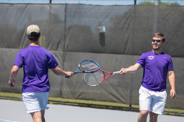 Waterville's doubles teammates Ben Danner (left) and John Evans congratulate one another during a doubles match against Ellsworth in the Class B North semifinals Saturday afternoon at Colby College in Waterville.