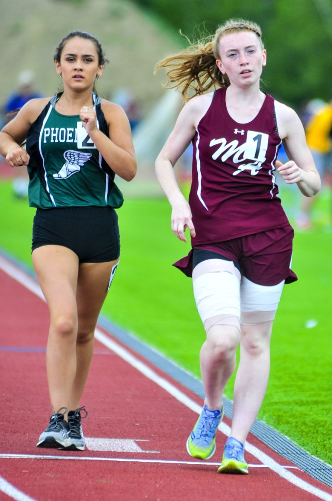 Staff photo by Joe Phelan 
 Spruce Mountain's Emily White, left, came in second with a 7:52.53 just behind Monmouth Academy's Moira Burgess's 7:52.43 in the 1,600 meter race walk at the Class C track and field state meet Saturday in Waterboro.