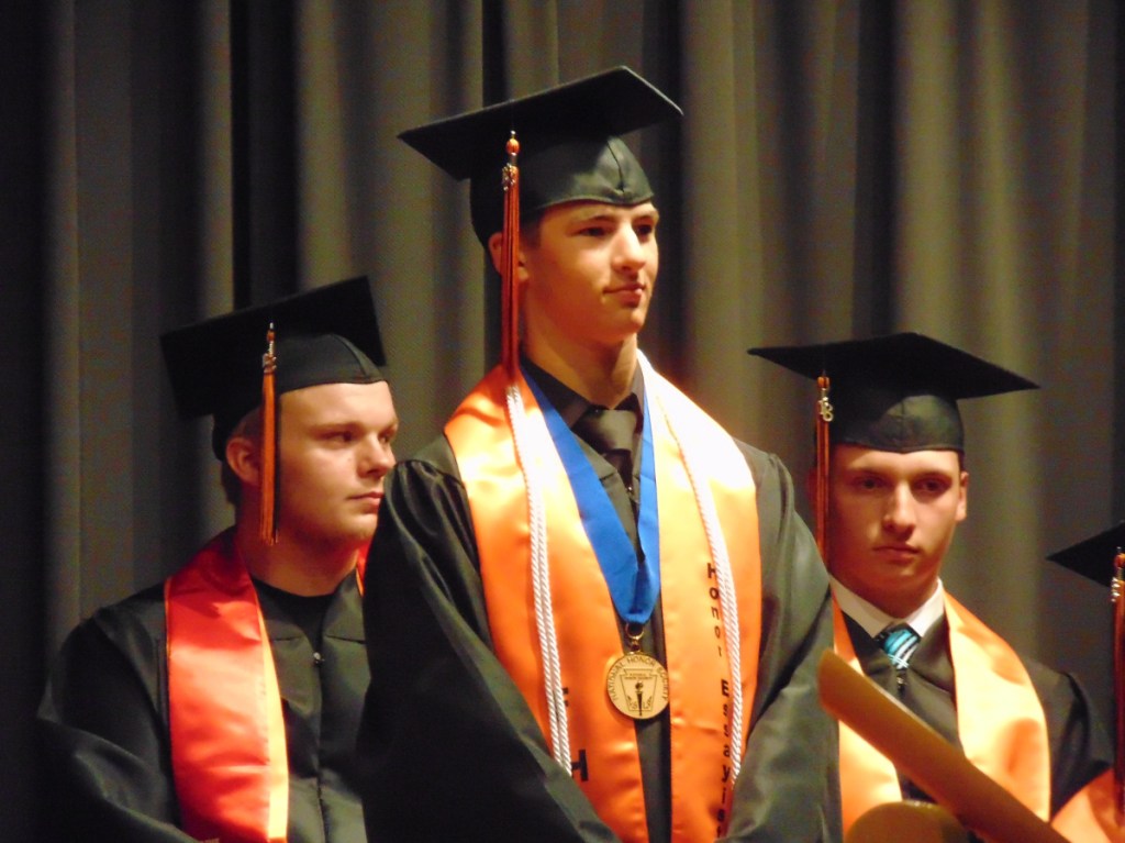 Forest Hills class of 2018 Honor Essayist, Carson Veilleux, stands as he is recognized by a fellow graduate during Saturday's ceremony in Jackman. Veilleux also spoke during the ceremony, warning his classmates against the pull toward their generation's culture of instant gratification.