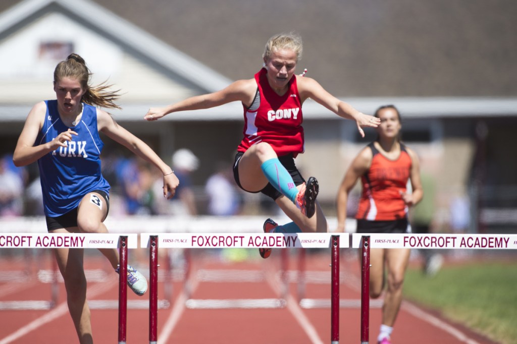 Staff photo by Michael G. Seamans 
 Cony's Anna Reny competes in the 300 meter hurdle at the Class B track and field state championships Saturday at Foxcroft Academy.