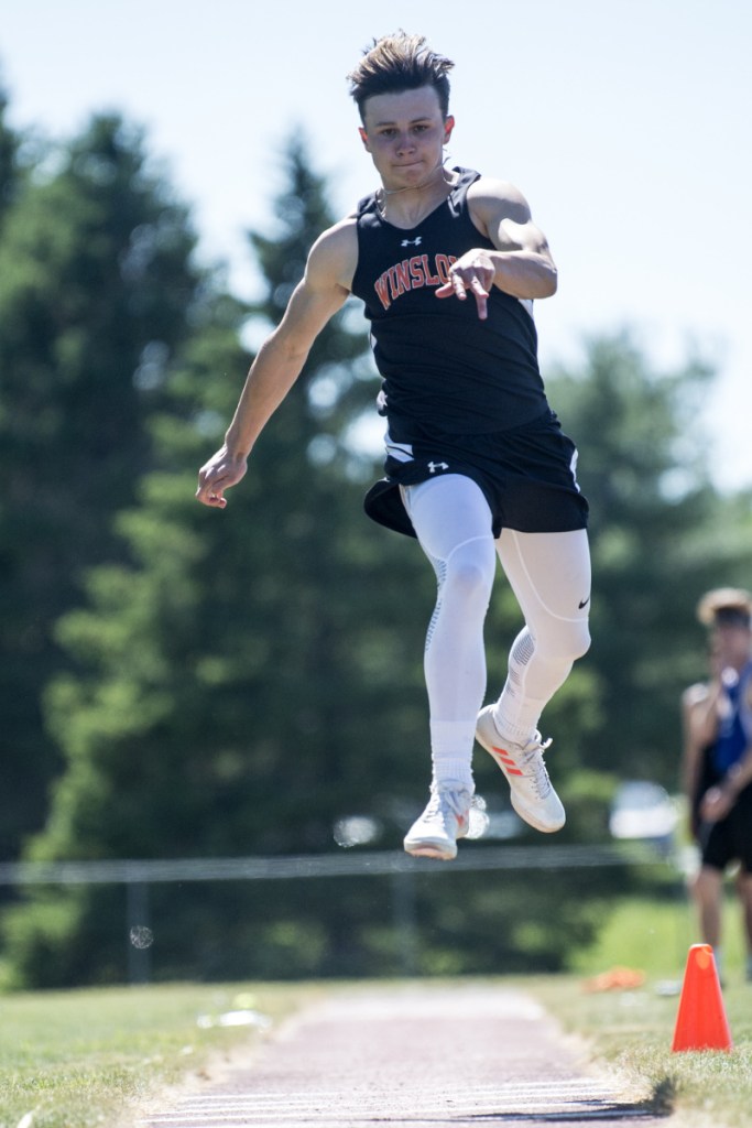 Staff photo by Michael G. Seamans 
 Winslow's Jake Warn competes in the triple jump at the Class B track and field state championships Saturday at Foxcroft Academy.