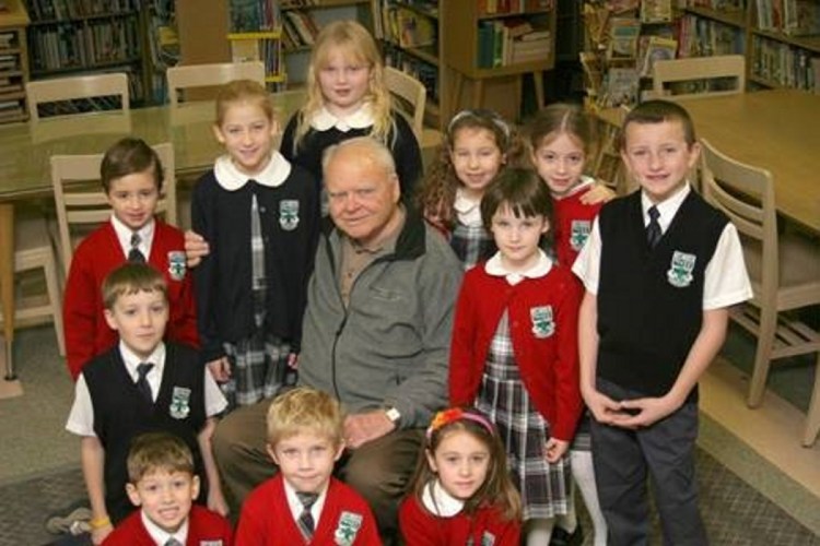 Mount Merici Academy received a gift of $83,000 from a unitrust set up by Joseph Alfred "Fred" Boucher, pictured here surrounded by Mount Merici students. Boucher died in 2011 at the age of 88.