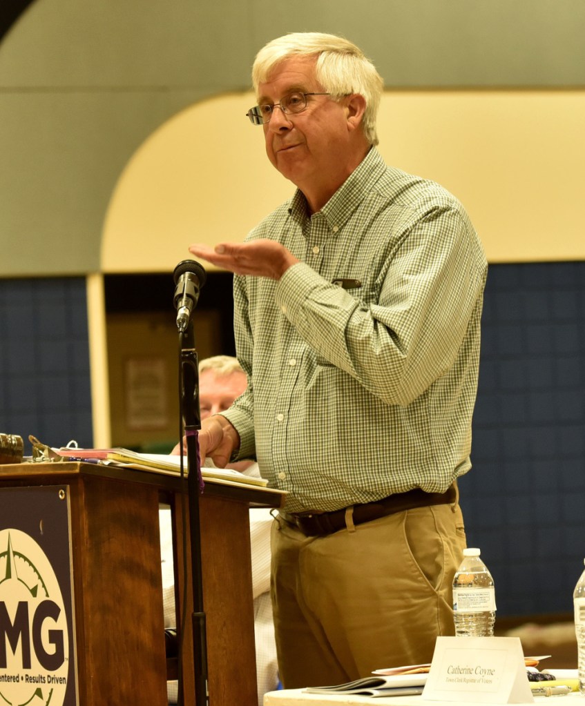 Vassalboro Selectman John Melrose answers a question on the town budget Monday during the Vassalboro Town Meeting.