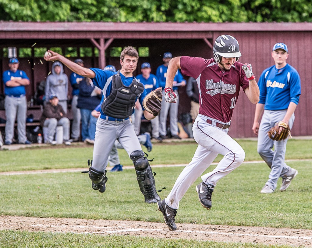 Monmouth Academy's Devon Poisson sprints to first base as Mt. Abram catcher Ben Debias throws the ball to first base during Tuesday's Class C South prelim game in Monmouth.