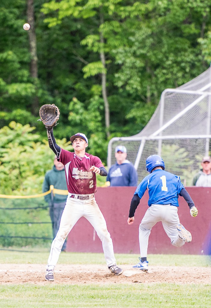 Monmouth Academy's Avery Pomerleau forces an out on Mt. Abram's Kenyon Pillsbury in the last inning of Tuesday afternoon's Class C South prelim game in Monmouth.