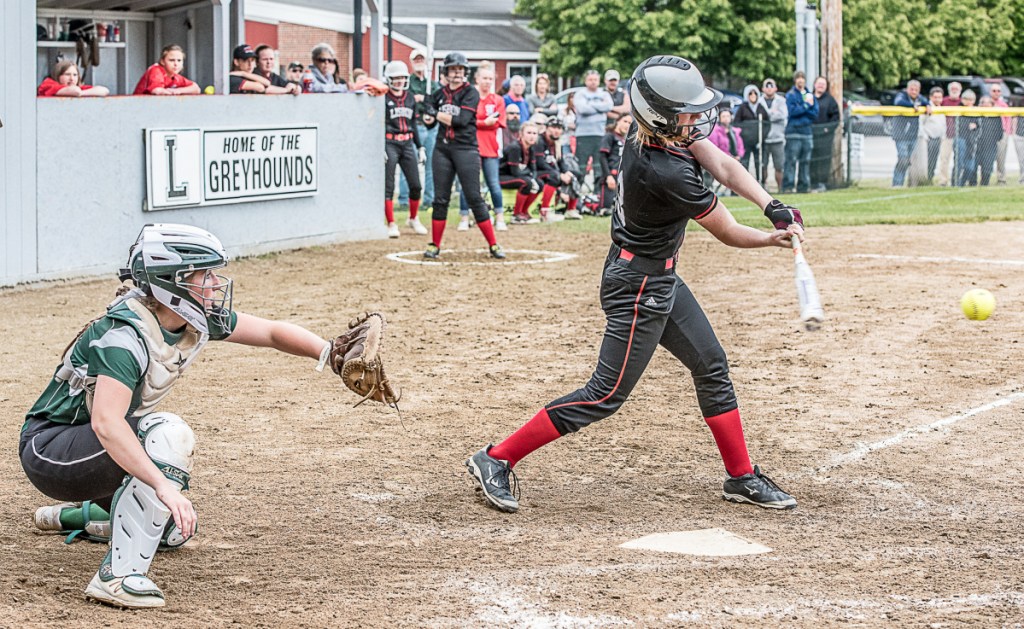 Lisbon's Ivy Morris connected for a key hit in the sixth inning in front of Carrabec catcher Bailey Dunphy during a Class C South quarterfinal game Wednesday in Lisbon.