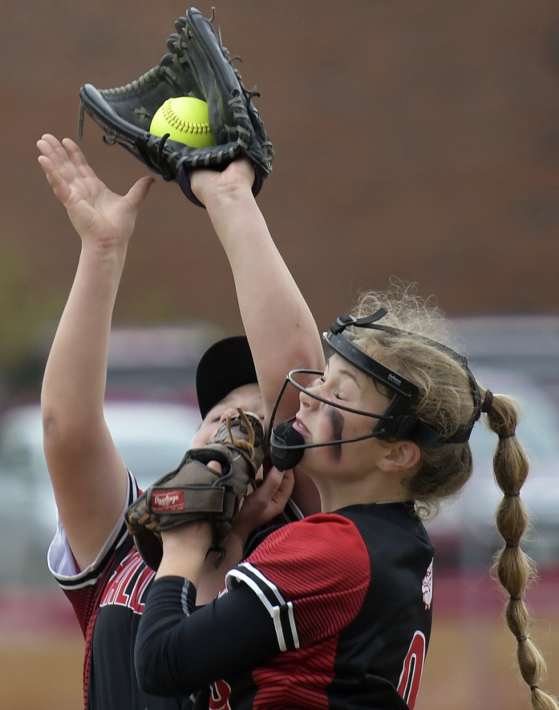 Staff photo by Andy Molloy 
 Hall-Dale's Sarah Benner, right, and Grace Begin collide collecting a pop up hit by a Maranacook batter during a Class C South prelim game Wednesday in Farmingdale.