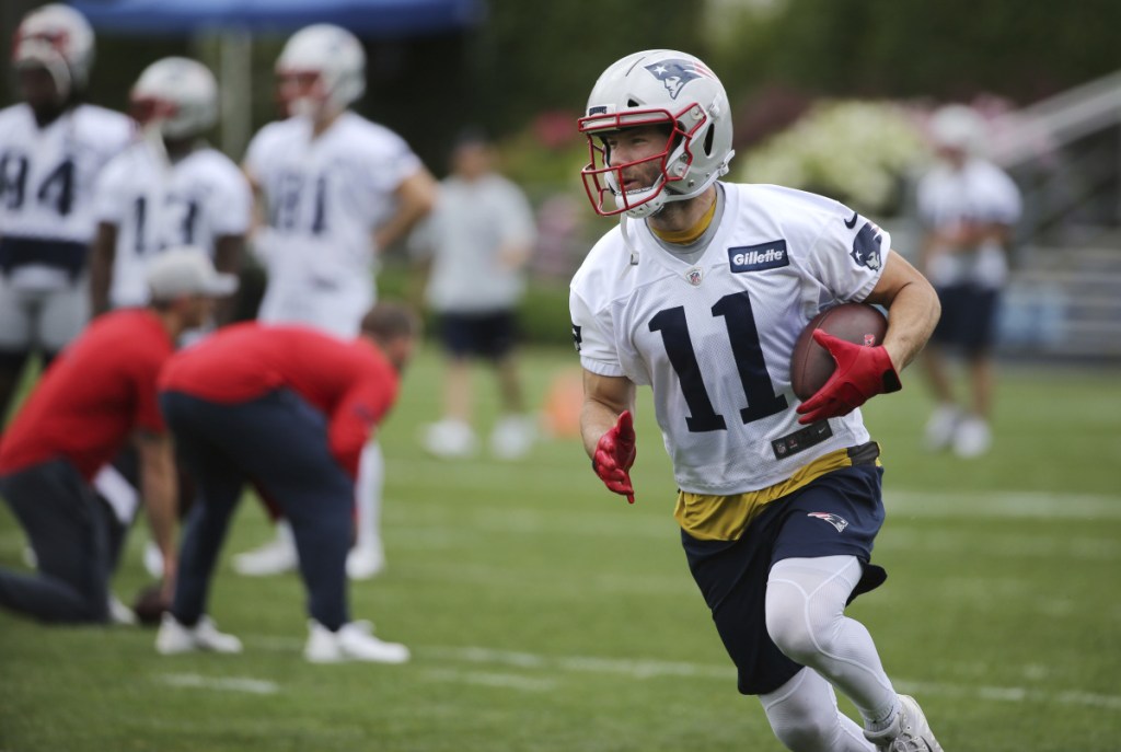 New England Patriots wide receiver Julian Edelman runs with the ball during minicamp practice Wednesday in Foxborough, Massachusetts.