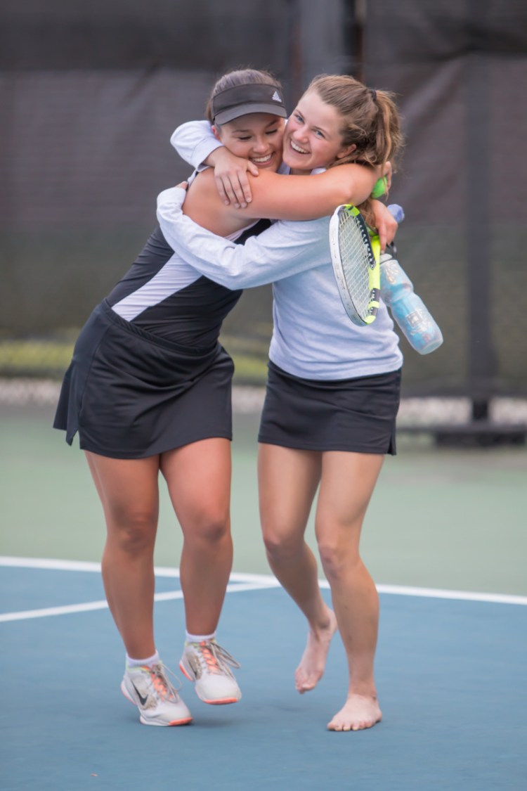 Photo by Jennifer Bechard 
 Maranacook singles players Emma Wadsworth, left, and Madelyn Dwyer embrace after the the Black Bears sank Carrabec to win the Class C South championship Thursday afternoon at Bates College in Lewiston.