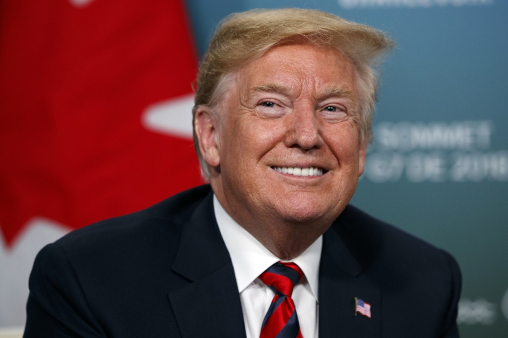President Donald Trump smiles during a meeting with Canadian Prime Minister Justin Trudeau during the G-7 summit Friday in Charlevoix, Canada.