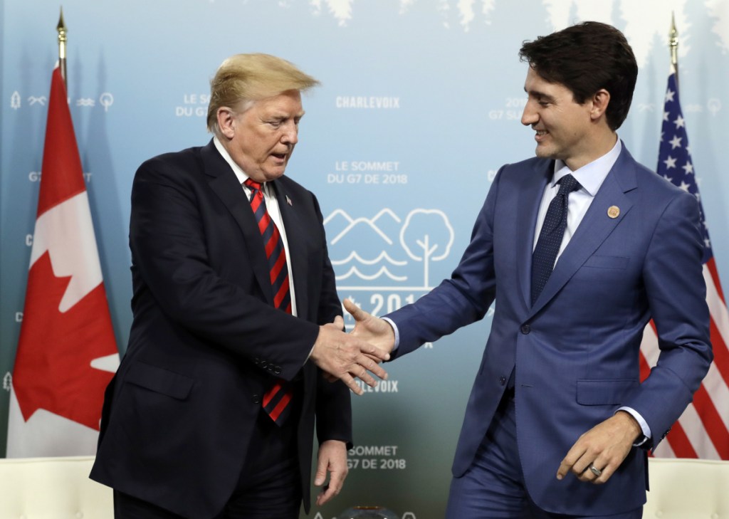 U.S. President Donald Trump shakes hands with Canadian Prime Minister Justin Trudeau during a meeting at the G-7 summit Friday in Charlevoix, Canada.
