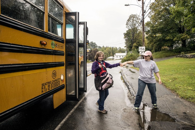 Siiri Stinson helps her daughter Leah off the bus Sept. 6, 2017, at the end of their driveway in Wilton. Leah requires 24-hour supervision. She received one-on-one care all day at school, was walked directly to her school bus and dropped off with her waiting mother. If Siiri was not at the driveway, the bus would continue on and return later until someone was there to receive Leah.