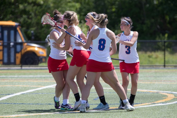 Messalonskee girls lacrosse players celebrate after they went up on Biddeford in a Class B playoff game Saturday at Thomas College.