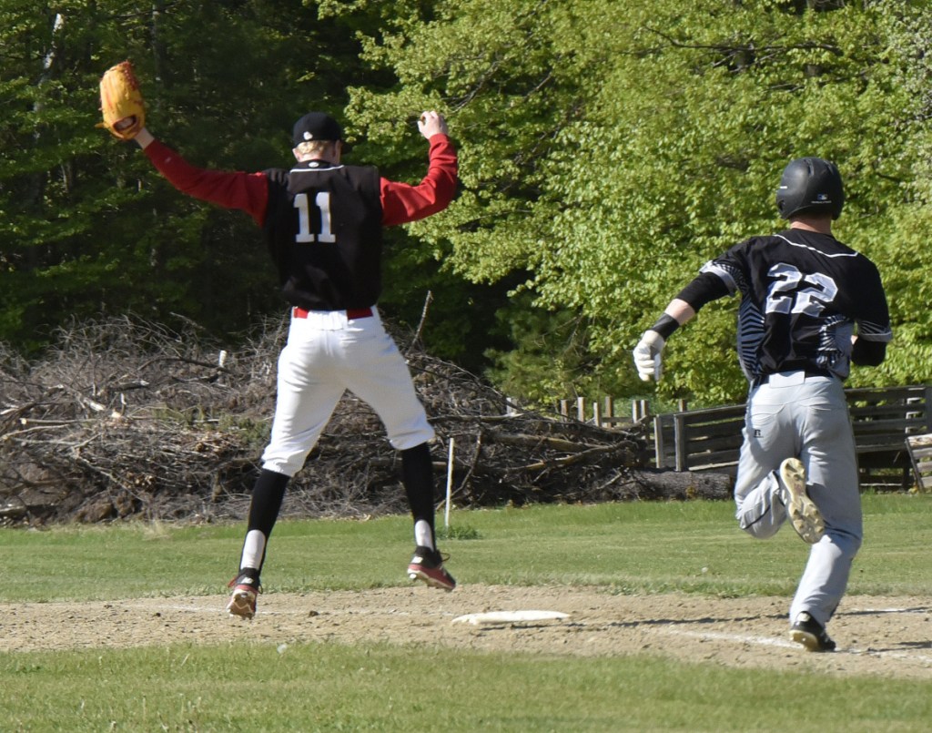 Hall-Dale's Dean Jackman (11) runs to record a forceout out as Bridgeway baserunner Evan Bess races to first base during a May 23 game.