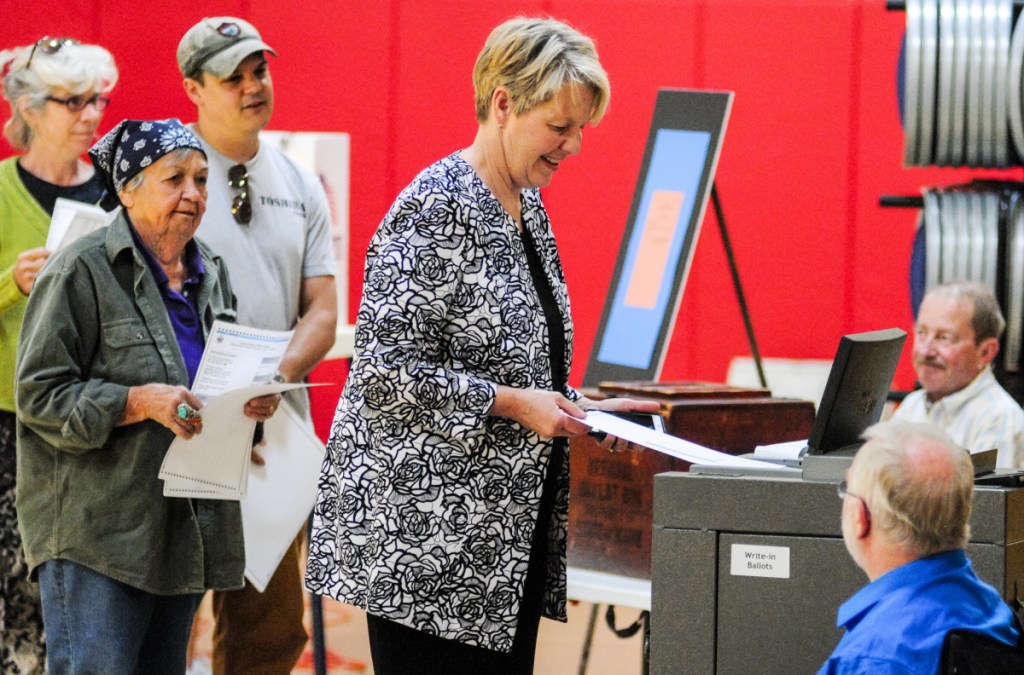 Democratic gubernatorial candidate Betsy Sweet casts her ballot on Tuesday in Hall-Dale Elementary School gym in Hallowell. Sweet said that she voted for herself first and Mark Eves second, but kept the rest of her choices on the ranked choice primary ballot private.
