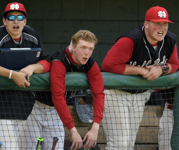 Staff photo by Andy Molloy 
 Hall-Dale players Cole Lockhart, right, Dean Jackman and Cole Perry cheer on their team during the Class C South championship game Tuesday against Maranacook at St. Joseph's College in Standish.
