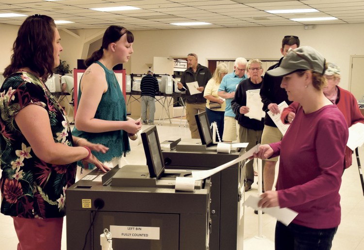 Winslow resident Michelle Dugal casts her ballot at the VFW in Winslow on Tuesday.