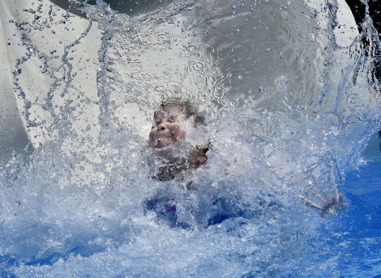 Logan Laskey blasts into the water Sunday from the big water slide at the Alfond Municipal Pool complex in Waterville. The City Council voted unanimously Tuesday to award a contract to replace the pool to Vortex Aquatic Structures International, which was the low bidder at $762,702. The pool is open Monday through Friday from 12:30 p.m. to 7 p.m. and weekends 11 a.m. to 6 p.m.