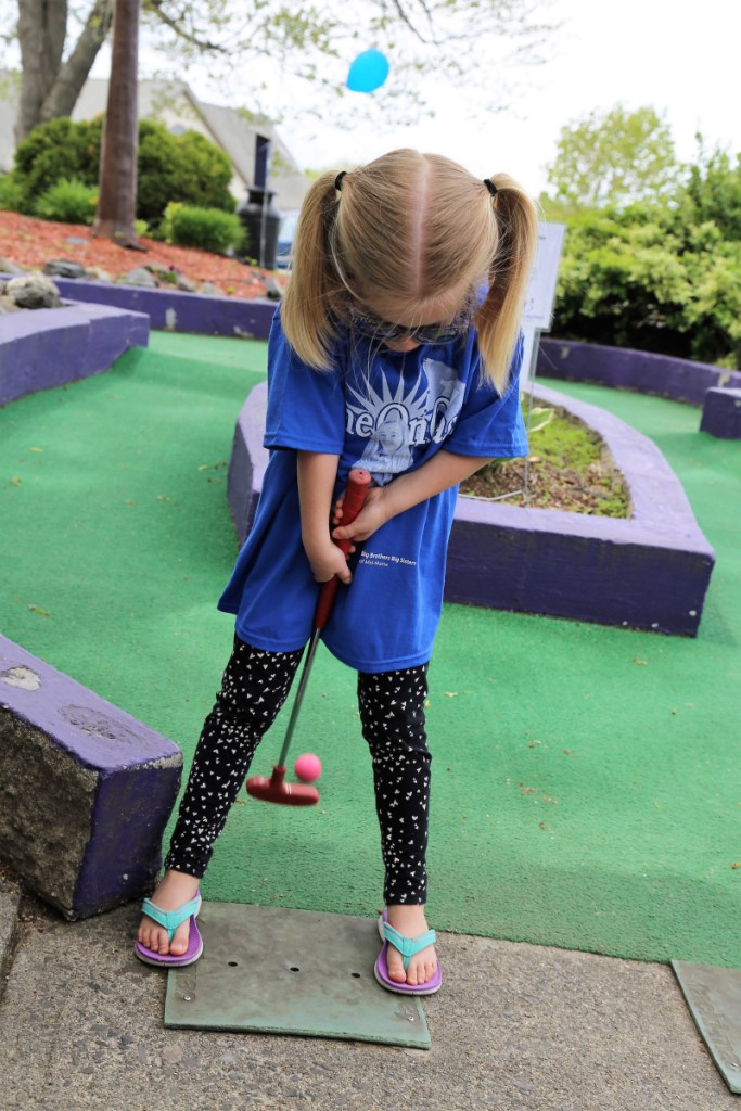 Ava Belknap tries her hand at backwards putting during the Putt 4 Cass event held May 19 at Gifford's Famous Ice Cream & Mini Golf.