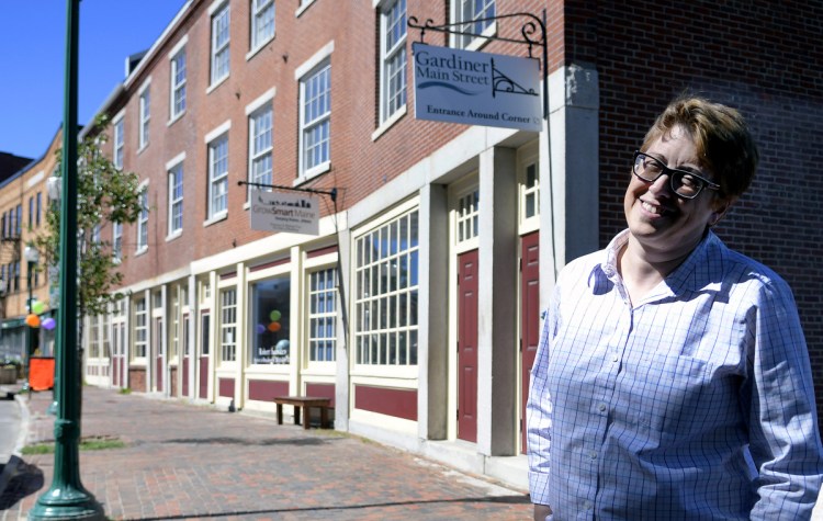 Piper Panzeri, Gardiner Main Street's new executive director, stands on Water Street on Tuesday in Gardiner.