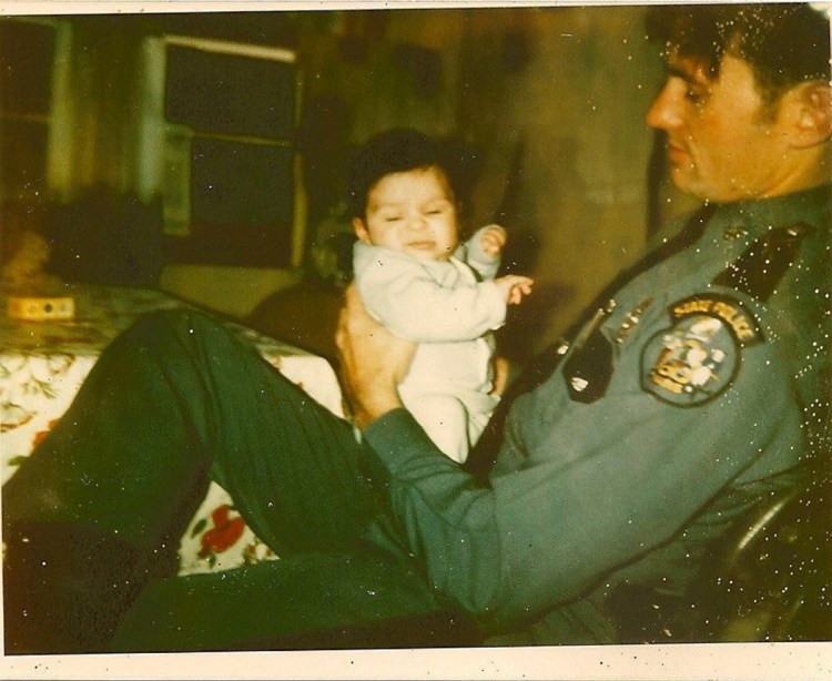 Maine State Trooper Thomas Merry holds his son, Ben, in 1980. Trooper Merry was killed weeks later setting up a roadblock on U.S. Route 2 in Palmyra.