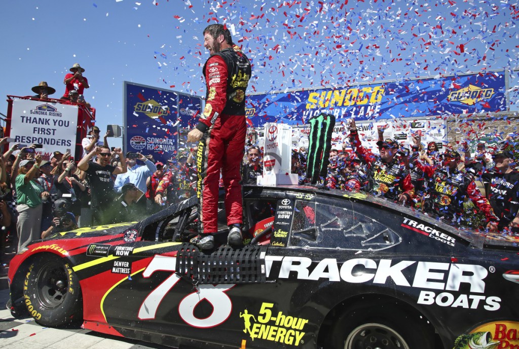 Martin Truex Jr. celebrates after winning a NASCAR Sprint Cup Series race Sunday in Sonoma, California.